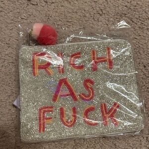 Francesca’s Rich as F*ck coin purse with Pom Pom zipper